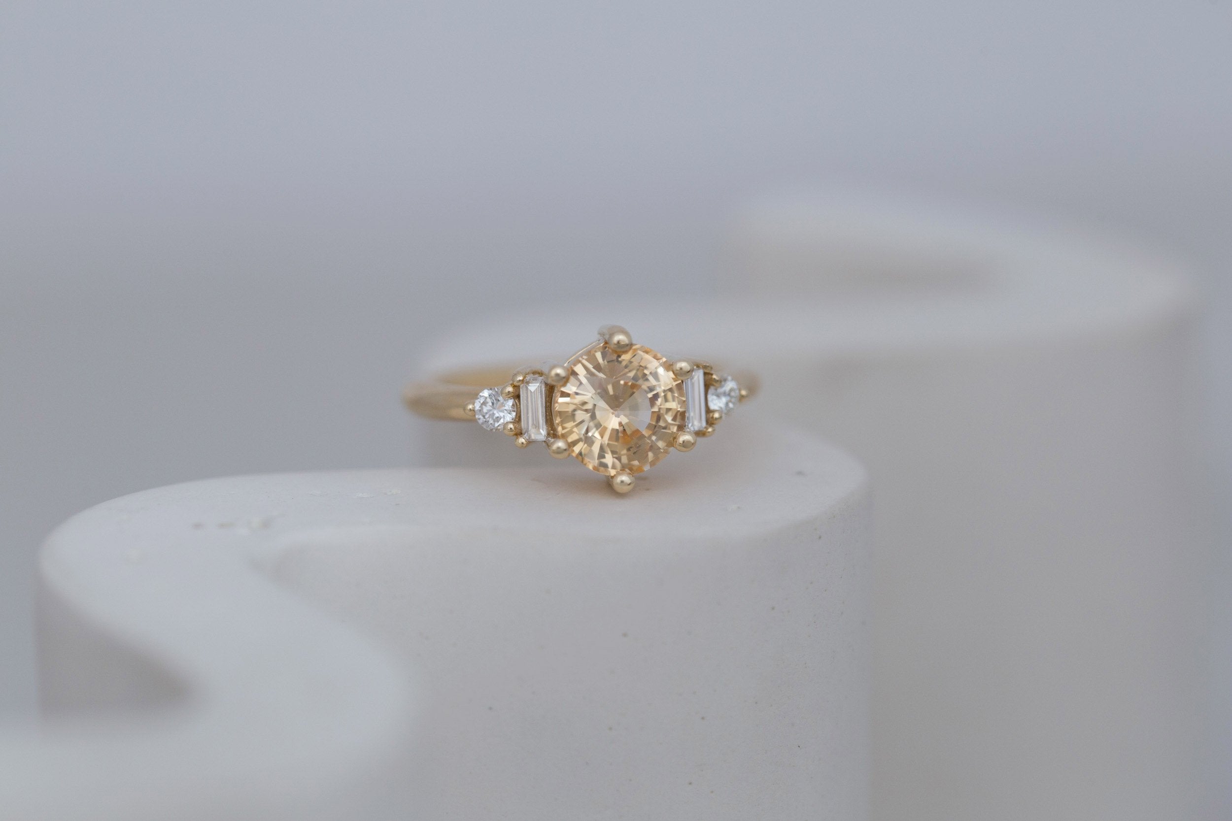 Alsea Ring | Apricot Sapphire + Baguette and Round Diamond Accent Engagement Ring 2.09 ct | 14k Recycled Gold | One of a Kind