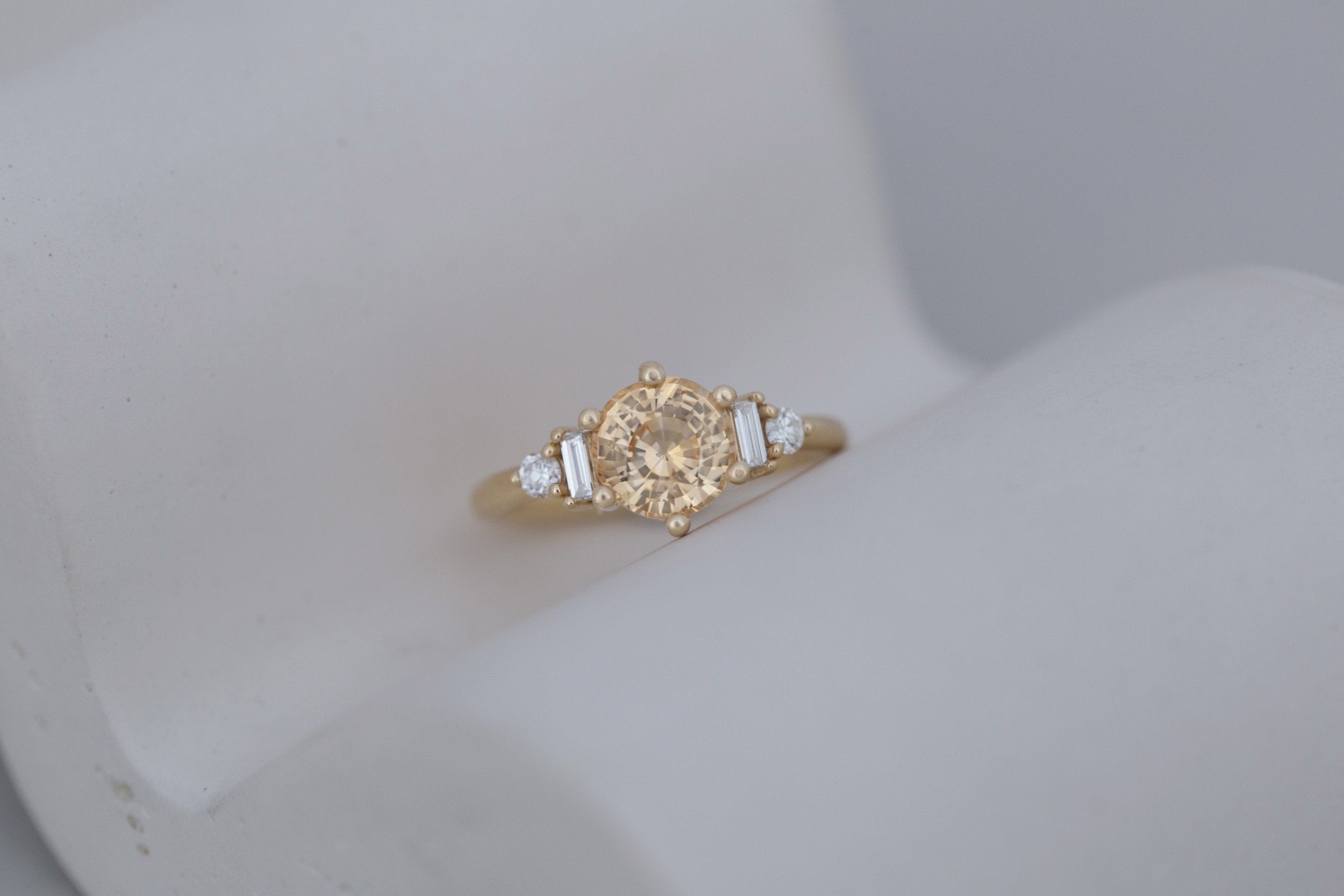 Alsea Ring | Apricot Sapphire + Baguette and Round Diamond Accent Engagement Ring 2.09 ct | 14k Recycled Gold | One of a Kind
