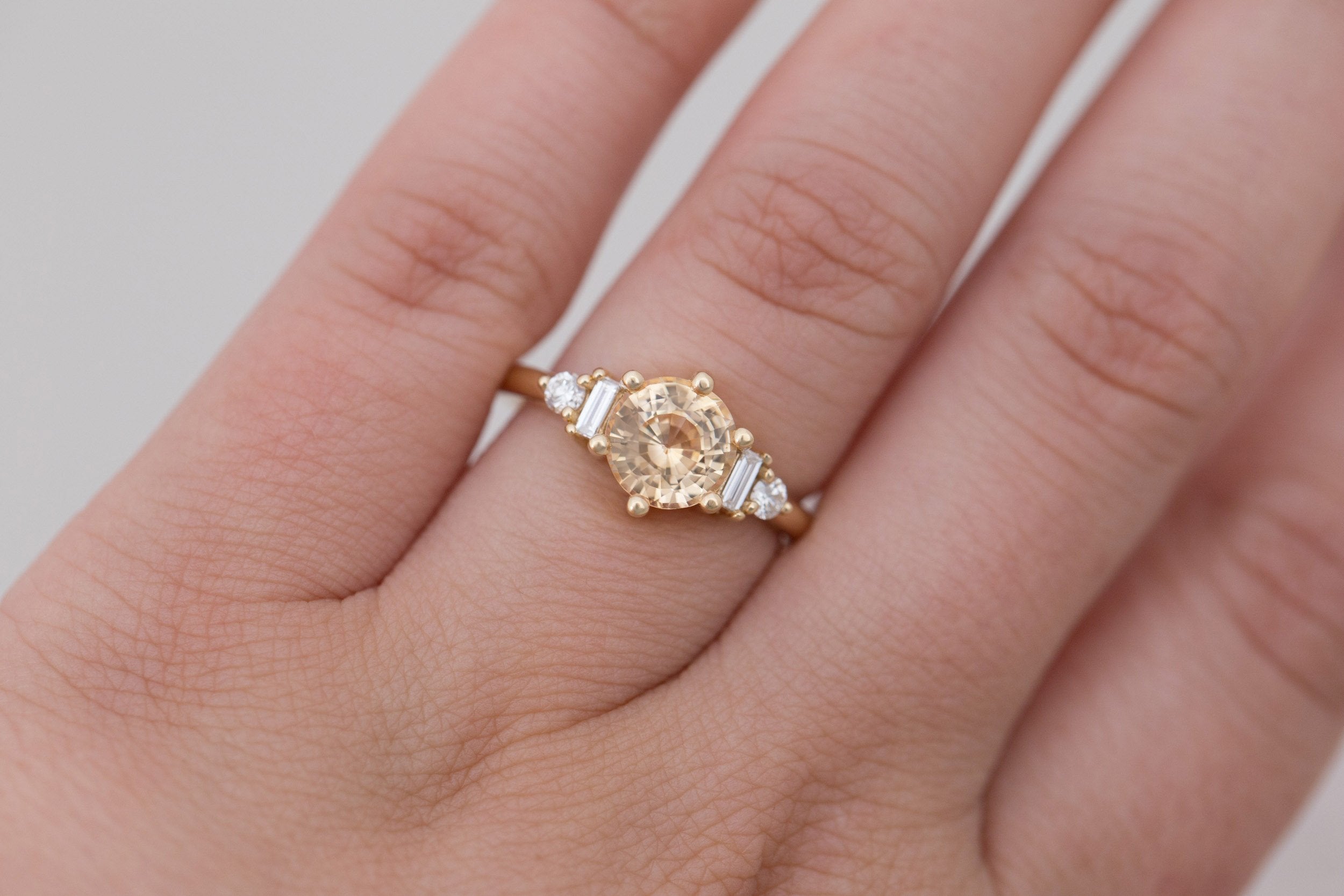 Alsea Ring | Apricot Sapphire + Baguette and Round Diamond Accent Engagement Ring 2.09 ct | 14k Recycled Gold | One of a Kind