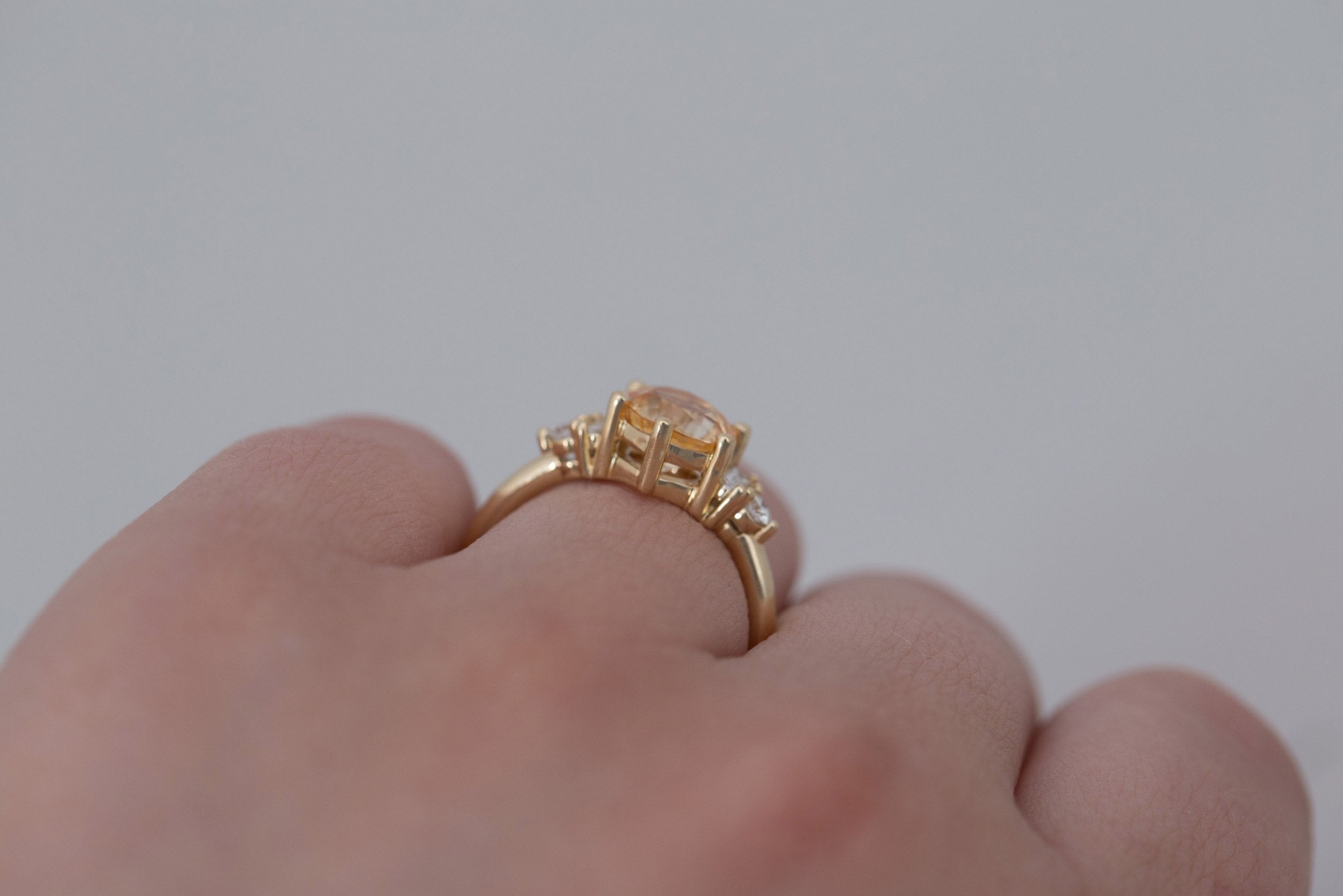 Alsea Ring | Apricot Sapphire + Baguette and Round Diamond Accent Engagement Ring 2.09 ct | 14k Recycled Gold | One of a Kind