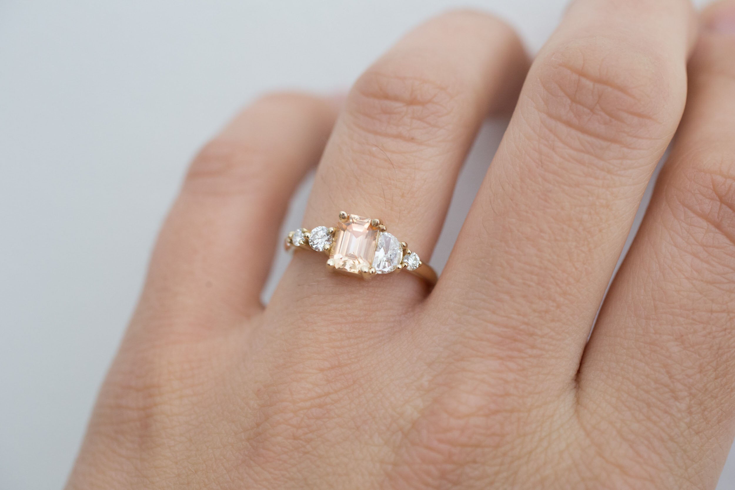 Sarine Ring | Apricot Sapphire + Half Moon Diamond + Diamond Cluster Engagement Ring | 14k Recycled Gold | One of a Kind