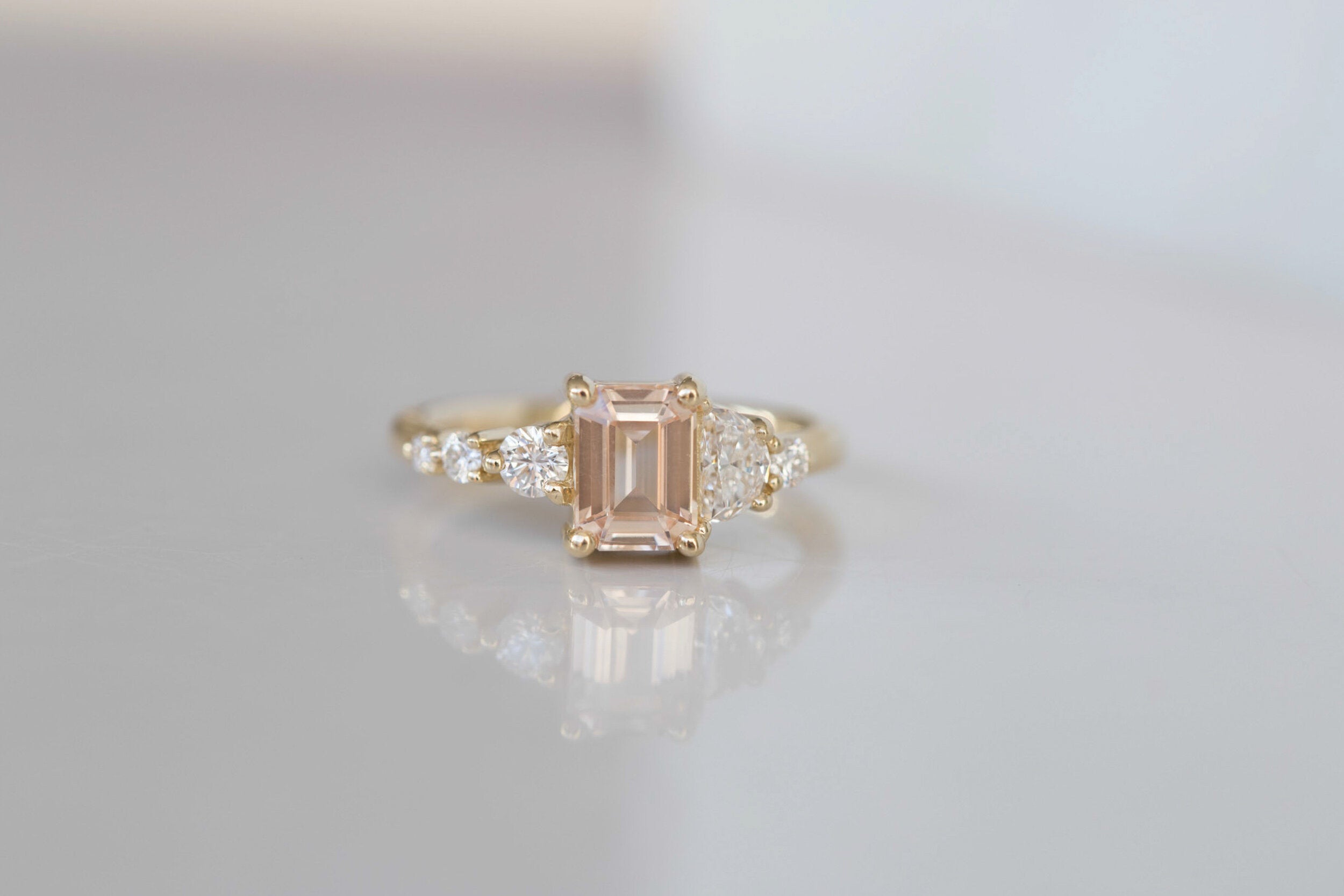 Sarine Ring | Blush Apricot Sapphire + Half Moon Diamond + Diamond Cluster Engagement Ring | 14k Recycled Gold | One of a Kind