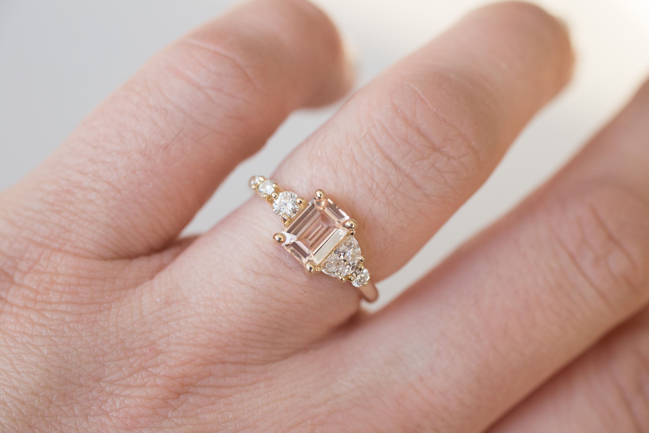 Sarine Ring | Blush Apricot Sapphire + Half Moon Diamond + Diamond Cluster Engagement Ring | 14k Recycled Gold | One of a Kind