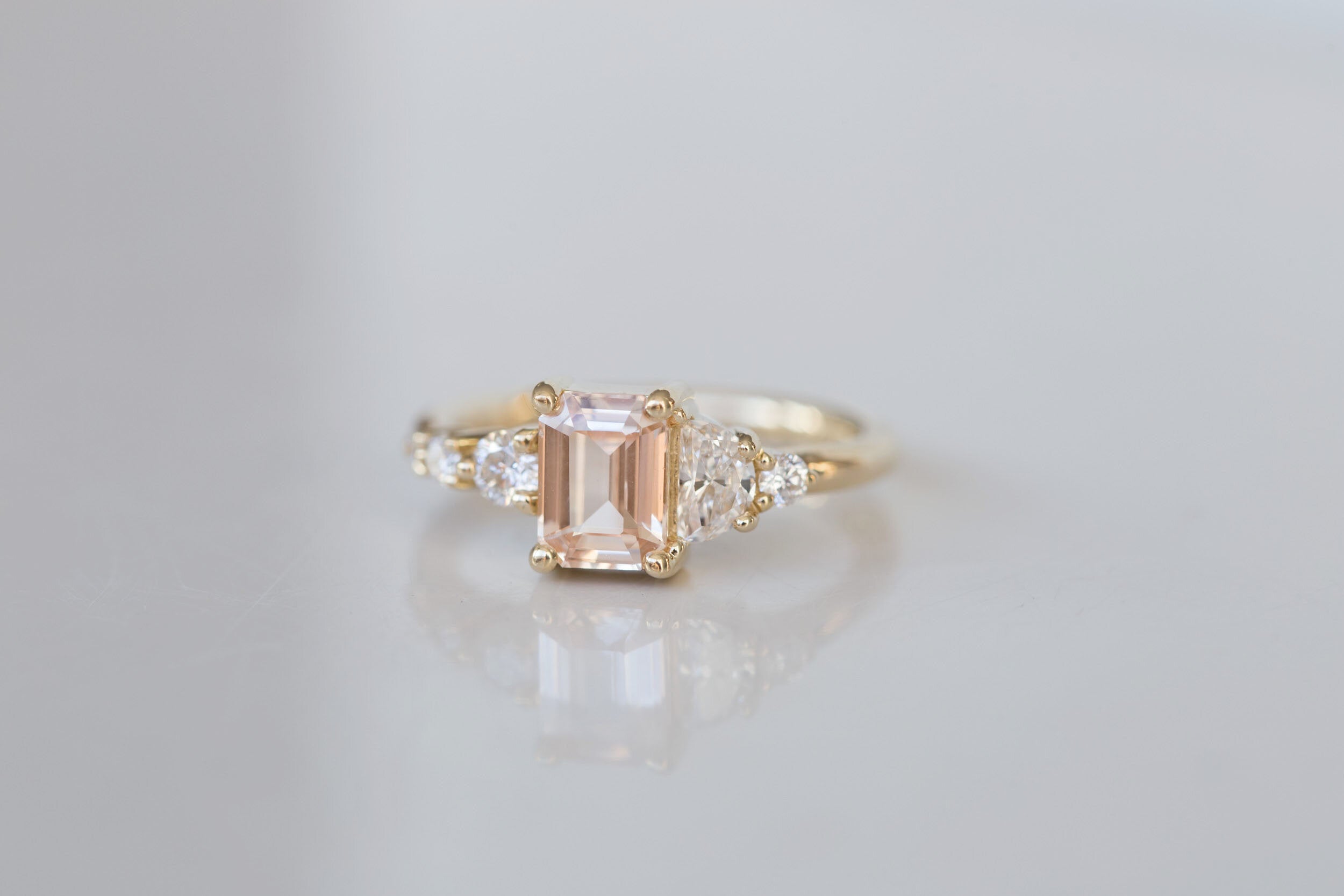 Sarine Ring | Blush Apricot Sapphire + Half Moon Diamond + Diamond Cluster Engagement Ring | 14k Recycled Gold | One of a Kind